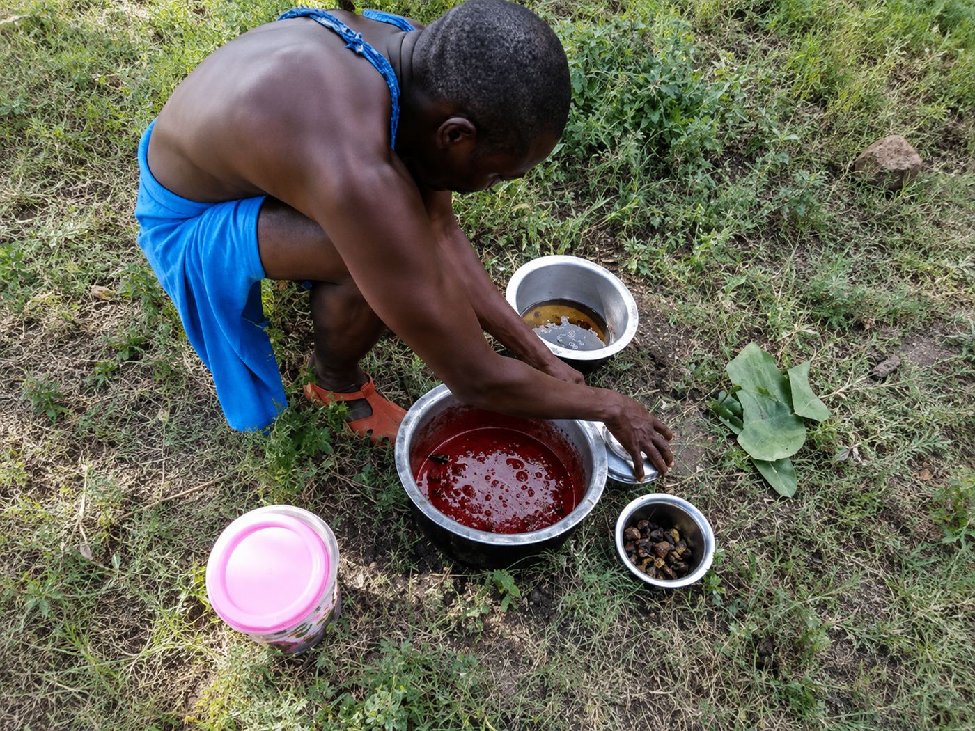 Preparing Munono, a traditional Maasai dish, in bowls at Nguruman Waterfront Resort