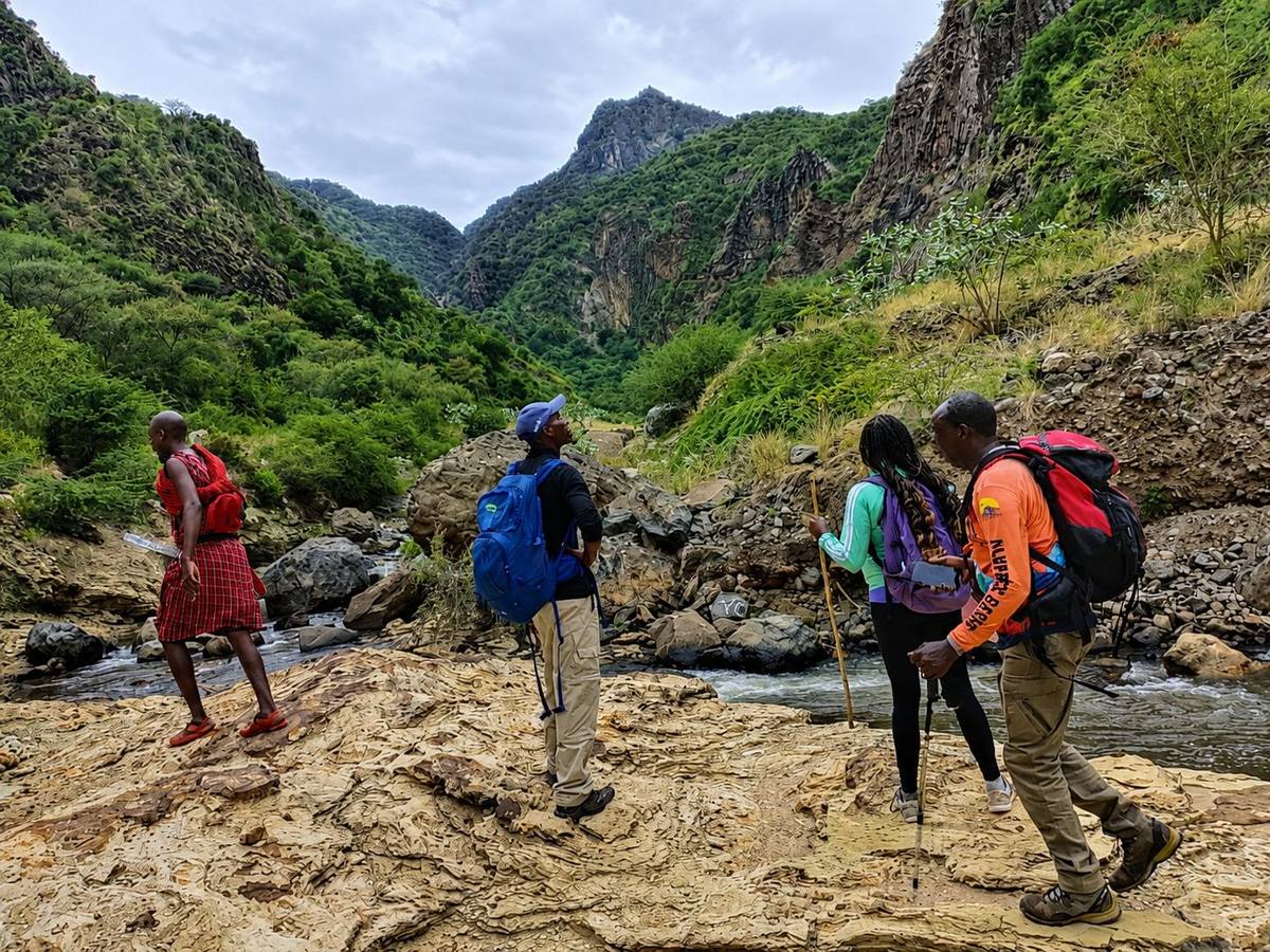 Guests and guide on a nature walk through the gorge near the river